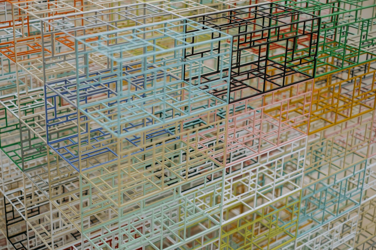 Cubi e prismi colorati in wireframe formano una complessa rete.